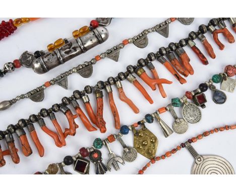 λFive Morocco amber mounted necklaces with additional beads of inlaid wood, silver coloured metal and glass, with pendants, 2