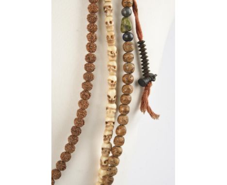 Three Tibetan mala beads including one with wood, stone and shell beads with two strands of iron discs and bell pendants, 57c