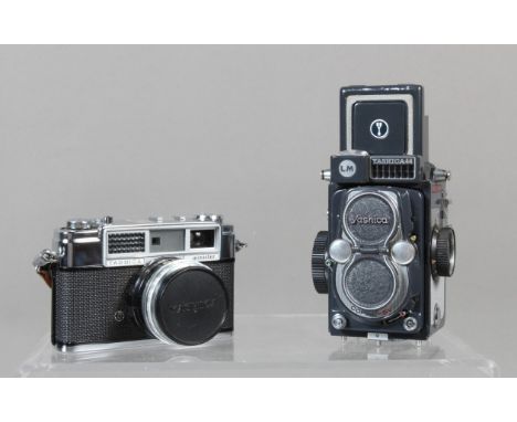 Two Yashica Cameras, a Yashica LM 44 TLR camera, shutter working, light cell responsive, body G-VG, some scratches to viewing