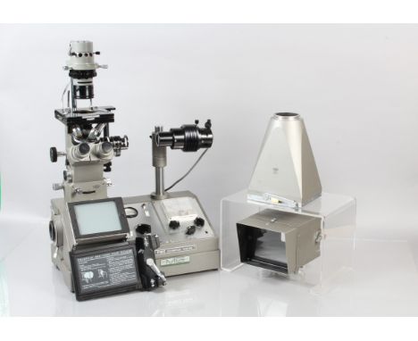 An Olympus PME Inverted Metallurgical Microscope, with two detachable light meters to rear, plastic dust cover, and associate
