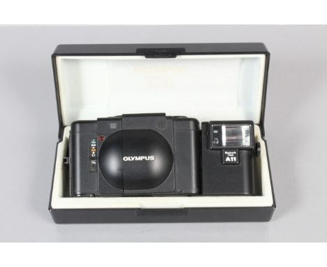 An Olympus XA Compact Camera, shutter working, meter responsive, rangefinder functions, self timer working, body G-VG, light 