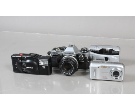 A Group of Olympus Cameras, an Olympus OM-10, shutter working, meter responsive, battery check/self timer selector loose, sel