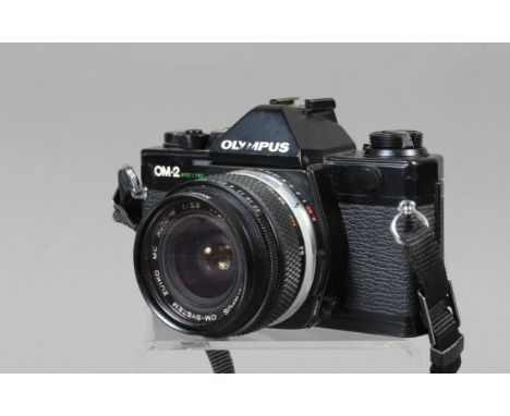 An Olympus OM-2 Spot Program SLR Camera,  black, serial no 1166438, shutter working, meter responsive, self timer working, bo