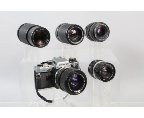An Olympus OM10 SLR Camera, shutter working, meter responsive, with manual adapter, body G, light wear, with S Zuiko 35-70mm 
