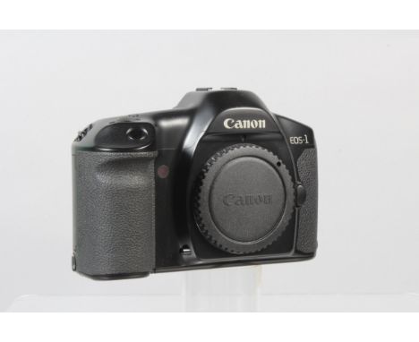 A Canon EOS 1 Camera Body, poers up, shutter working, appears to function as should, body G-VG, light wear, with body cap, ma