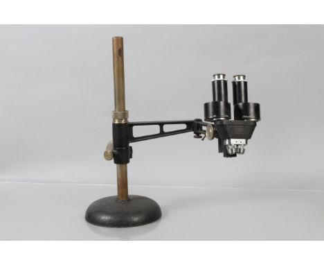 A Leitz black-enamelled Binocular Dissection or Inspection Microscope, with one objective set, mounted on gimbal with clamp a