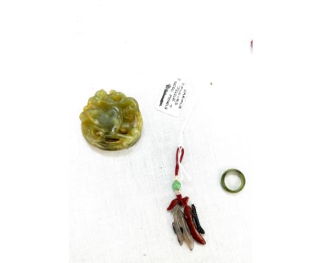 Selection of jade items includes carved figure, jade ring and a pendant 