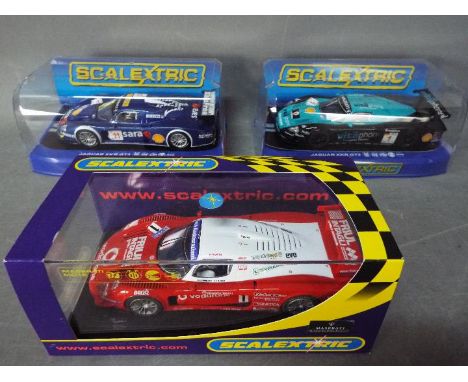 Scalextric - 3 x Maserati MC12 models in various colours and liveries including Vodafone. # C2784. All the cars appear Mint b