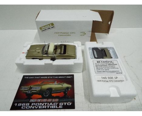 Danbury Mint - 1967 Pontiac GTO Convertible model in 1:24 scale. The car appears in Mint condition with the convertible top s