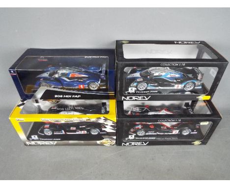 Norev - 4 x Peugeot 908 HDi FAP Le Mans cars in 1:18 scale in various liveries. All four cars appear Mint in Good display box