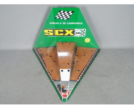 SCX - A vintage SCX perspex Shop Display Cabinet. The triangular shaped cabinet in green black, white with gravel effect base