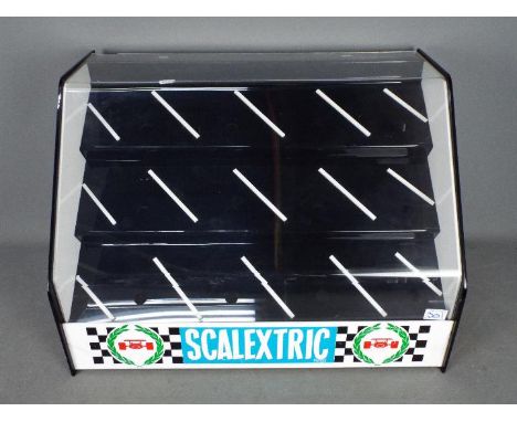Scalextric - A vintage Scalextric perspex Shop Display Cabinet. The cabinet in black and white perspex branded with the Scale