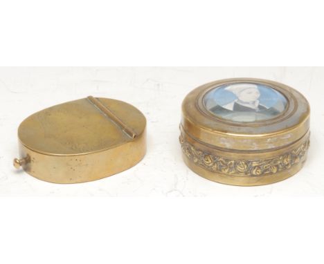 A George IV brass oval snuff box, the hinged cover engraved with leafy vines and faded lettering, sprung pin close, 8cm long 