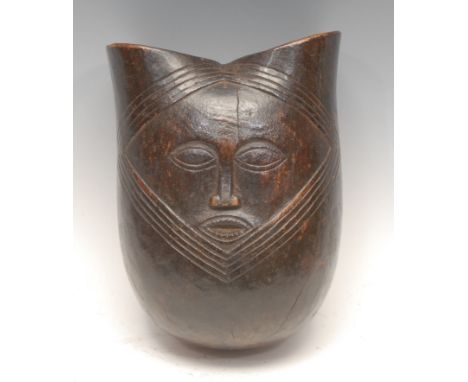 Tribal Art - a Kuba vessel, carved in relief with a stylised face, 21cm high, Democratic Republic of Congo