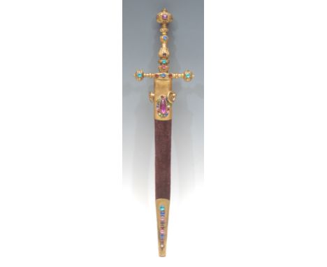 A Victorian brass novelty letter opener, as a Middle Eastern dagger, set with stones, the velvet draped sheath enclosing the 