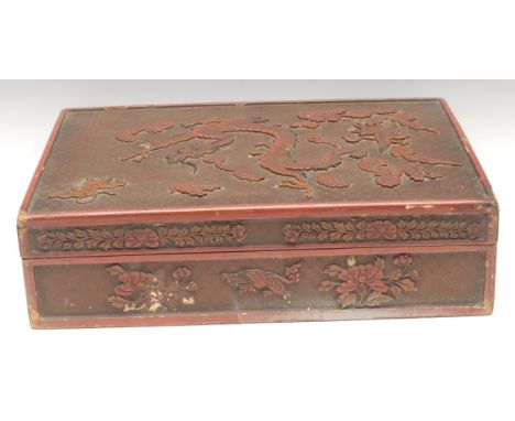 A large Chinese rounded rectangular cinnabar lacquer box and cover, carved with dragon, tiger, phoenix, temple lions, and flo