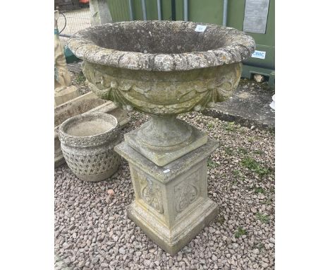 Large stone circular planter on plinth 