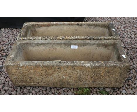 Pair of stone trough planters with feet 