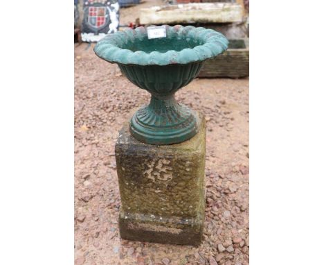 Small cast iron pedestal planter on stone plinth 