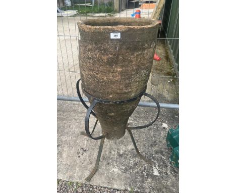 Old terracotta planter on metal base 