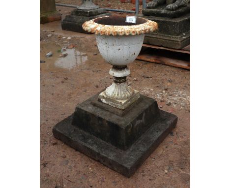 Small cast iron pedestal planter on stone base 