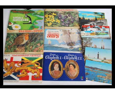 A collection of vintage tea cards in albums and loose along with cigarette cards and a quantity of post cards.