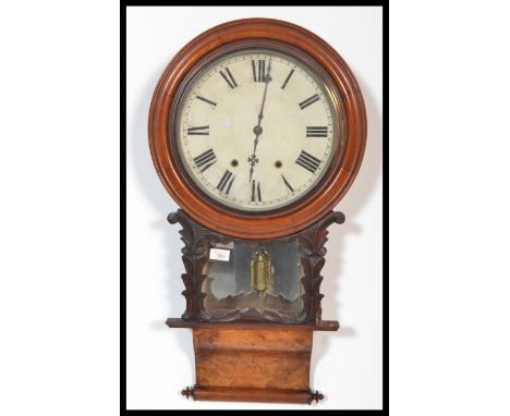 A 19th century Victorian American walnut wall clock having a carved pediment with turned columns. White enamel face with Roma