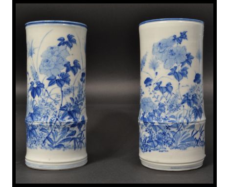 A pair of 19th century Chinese blue and white ceramic tall bamboo effect brush pots / vases hand painted with scenes of flowe