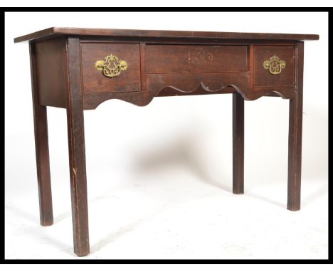 An 18th century Georgian mahogany lowboy writing table desk being raised on squared legs with fitted frieze having single dra