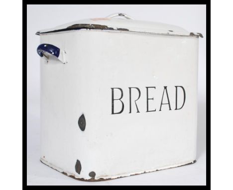 An early 20th century white enamel bread bid with lid and central notation together with a ' letter rack '. Measures 33 cm hi