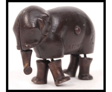 An original antique vintage Ives Company, Connecticut, patent 1873 cast iron jointed ramp walking elephant toy.