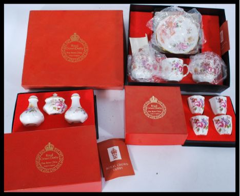 A collection of boxed Royal Crown Derby porcelain to include a set of 4 boxed cups, a boxed tea service for 3 and a boxed con