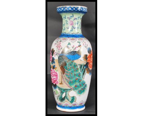 A 20th century Chinese famille rose floor vase / stick stand decorated with colourful scenes and character marks. Measures 62