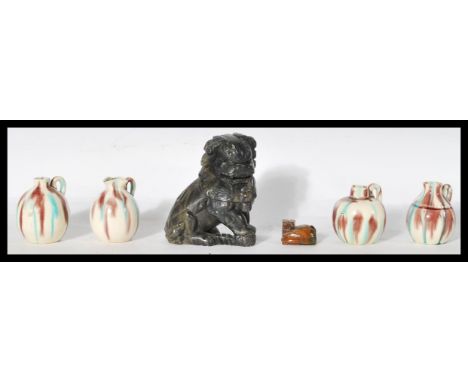 A collection of Oriental Chinese wares to include a set of four miniature pottery jugs of bulbous form , a carved soapstone f