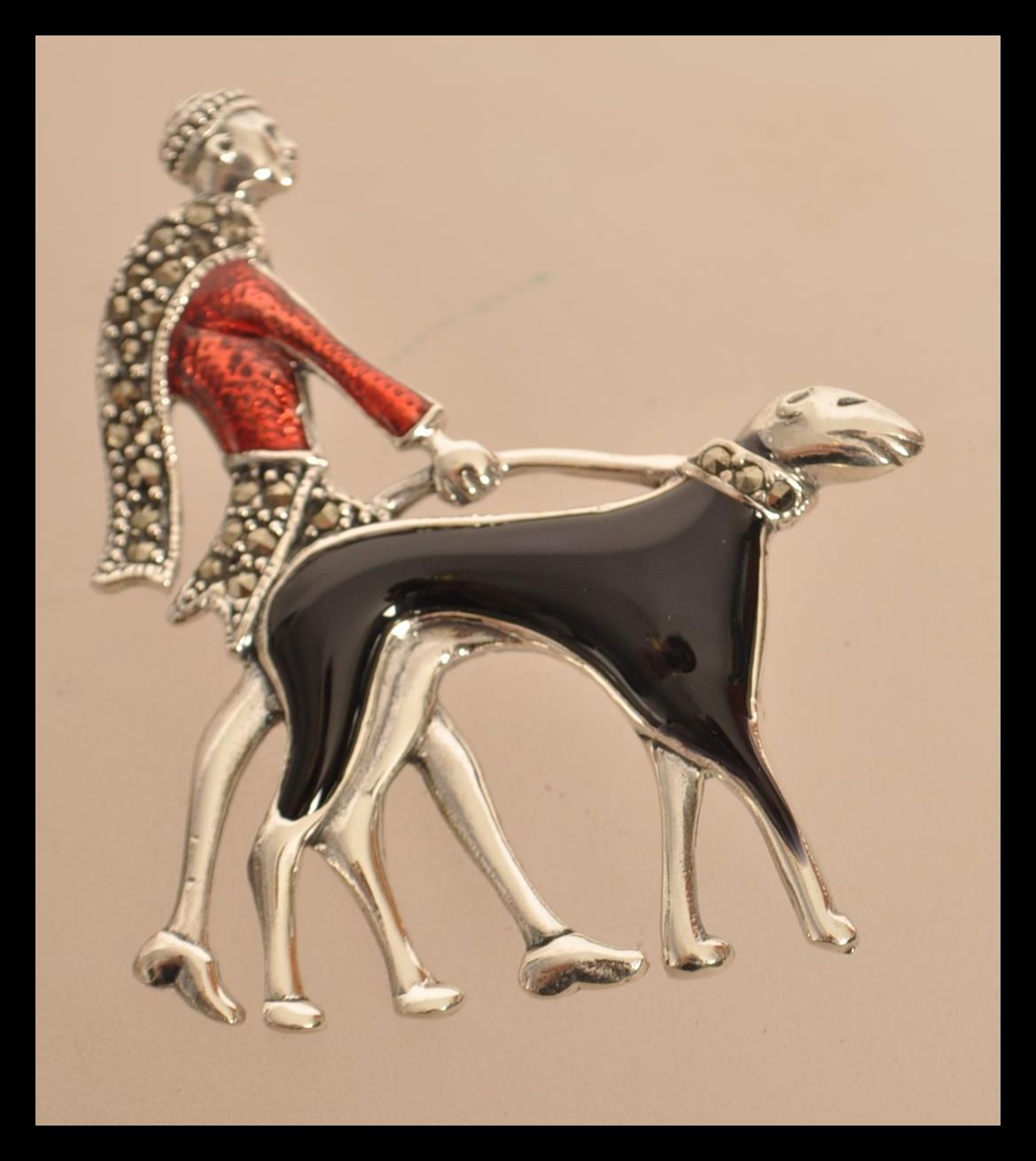 A sterling silver and enamel art deco brooch in the form of a lady