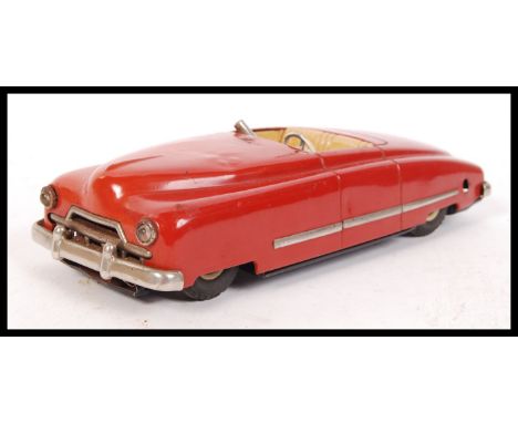 A retro vintage German Arnold Spielwaren tin plate wind up toy automobile JNF Favorit. Condition fair missing both figure and