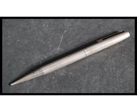 A silver hallmarked propelling pencil of larger form with engine turned decoration. Weighs 29.0 grams.