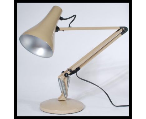 A vintage 20th century Herbert Terry anglepoise desk lamp being raised on circular terraced base with a pendant shade in taup