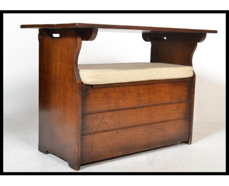 A good 20th century oak monks bench settle with carved panel front having hinged lid seat with fold over table / back rest&nb