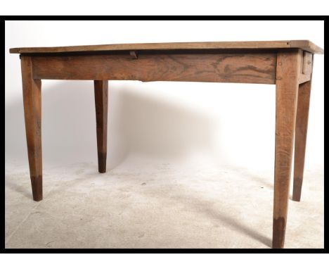 A country oak rustic 19th century, possibly French writing table desk. Of simple form raised on squared legs with fitted frie