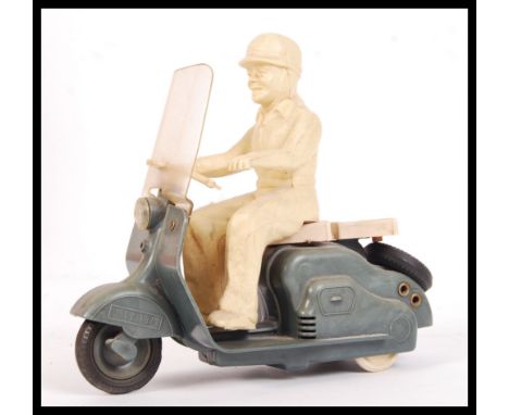 A rare vintage Mettoy made Moped Motorcycle and rider plastic friction powered toy. Complete with rider. Measures approx; 15c
