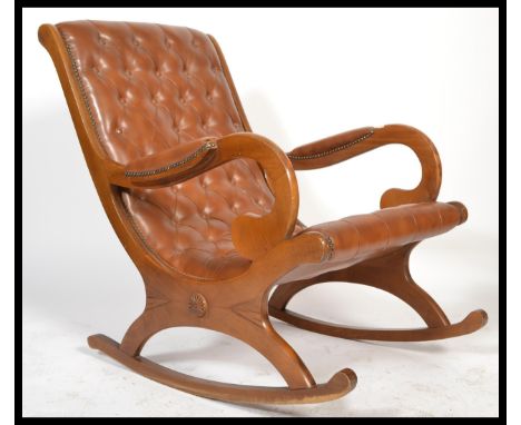 A Regency revival chesterfield button back slipper rocker chair raised on sleigh rocking supports. Upholstered in a cigarette