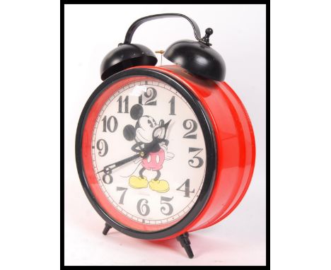 A vintage style oversized Walt Disney Company alarm clock by Sunbeam having the iconic Mickey Mouse on the round clock face h
