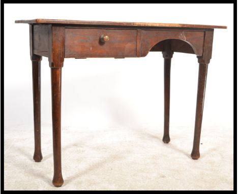 A 1930's Air Ministry George V stamped writing table desk being raised on turned tapering legs with pad feet. The rectangular