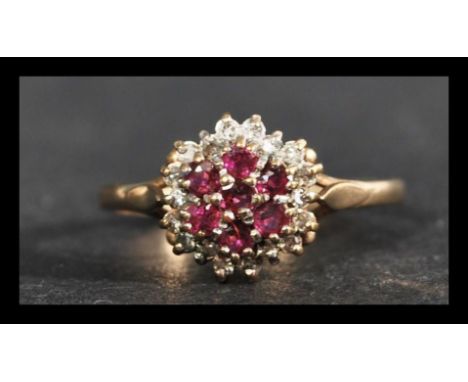 A hallmarked 9ct gold ruby and diamond cluster ring. Hallmarked Birmingham. Weight 2.1g. Size P.