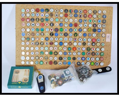 A large collection of enamel golf ball markers, collected from different golf clubs over a number of years.