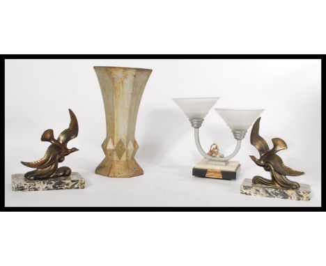 A group of Art Deco items to include a pair of spelter bird clock garnitures on marble bases , a cast metal trumpet form of g