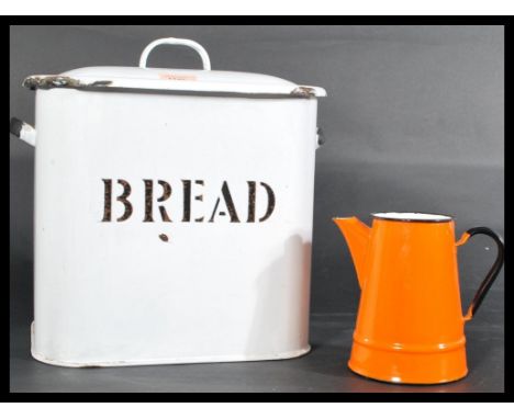 A vintage 20th centurty white metal painted enamel bread bin with notation and lid together with a enamelled dutch milk jug