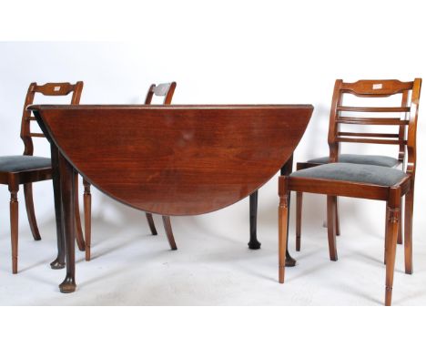 A 19th century Georgian mahogany drop leaf dining table being raised on turned legs with pad feet. The half moon leaves risin