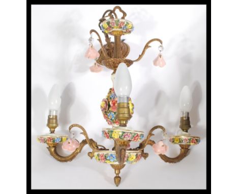 A vintage Italian floral encrusted crystal and brass three branch ceiling light chandelier having hand painted details.